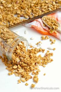 The warm spices of fall in a delicious granola blend. This Homemade Pumpkin Spice Granola Recipe is so easy to make and perfect sprinkled over a little bowl of yogurt or on its own. | @afewshortcuts #pumpkin #breakfast #granola #recipe #glutenfree #vegan #pumpkinspice
