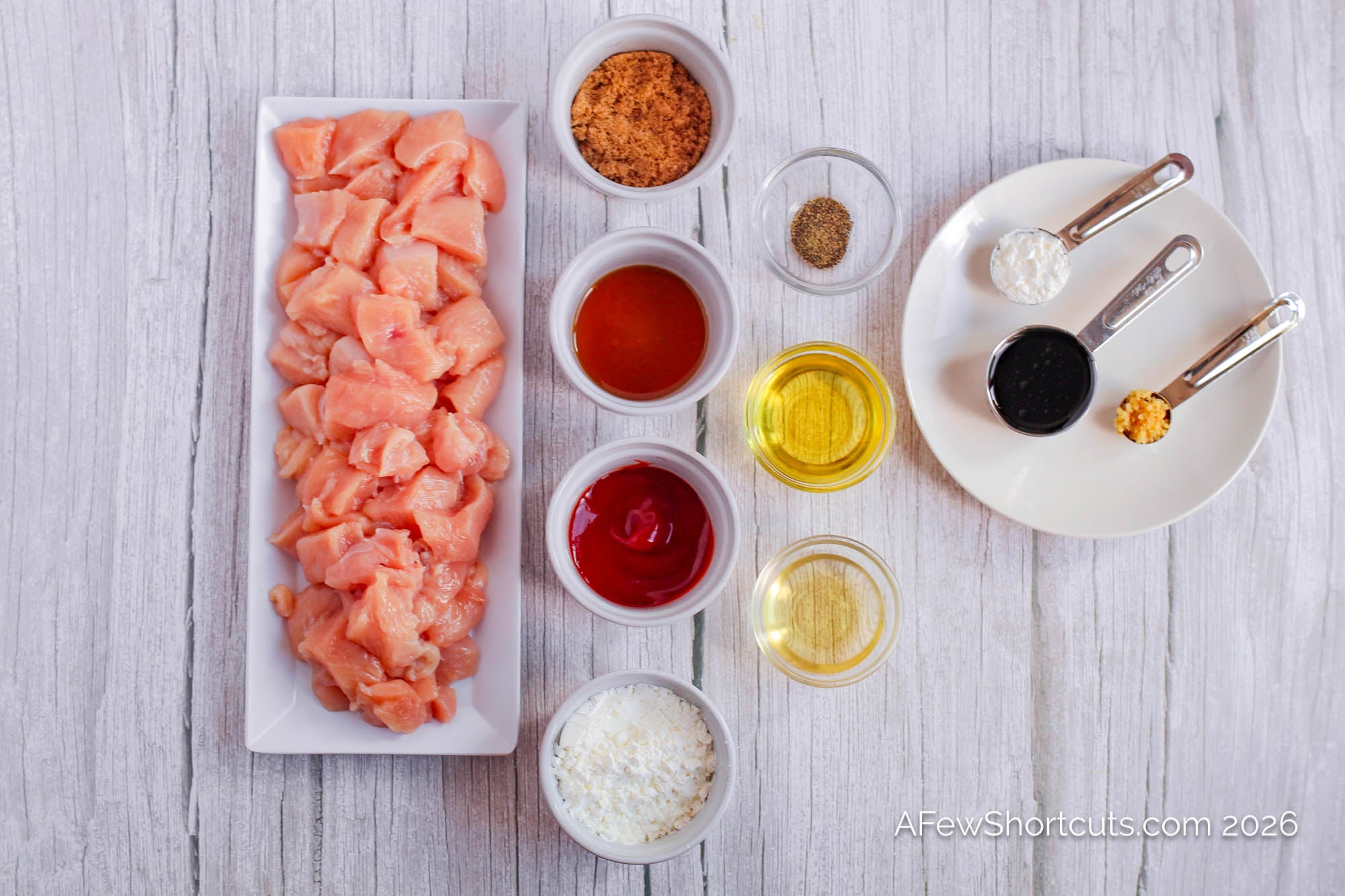 raw chicken and sticky sesame chicken sauce ingredients laid out